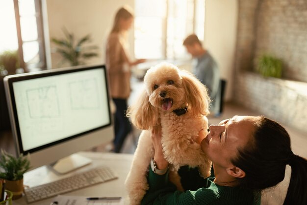 happy asian freelance worker having fun with her poodle office 637285 2540